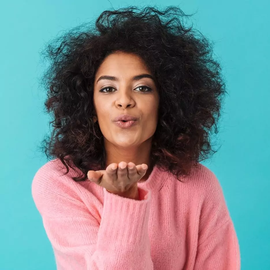 multicolor-image-of-flirty-woman-20s-with-afro-hairstyle-smiling
